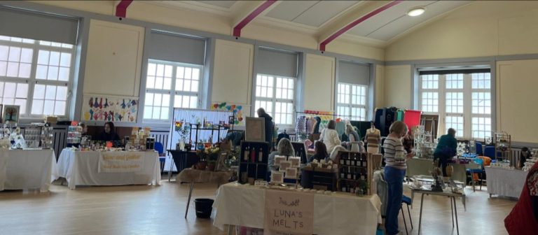 Visitors attending Largs SWI summer craft fair supporting women's community activities in Largs