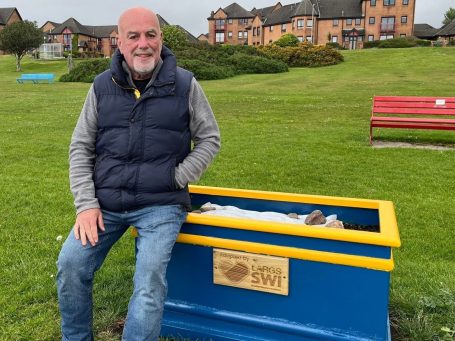 Members of Largs SWI maintaining community flower planters at Cairnies Quay in Largs