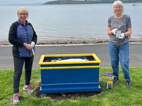 Members of Largs SWI maintaining community flower planters at Cairnies Quay in Largs
