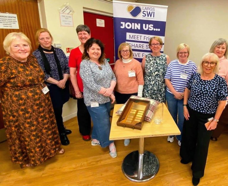 Largs SWI committee members celebrating the success and community achievements made possible through member support.